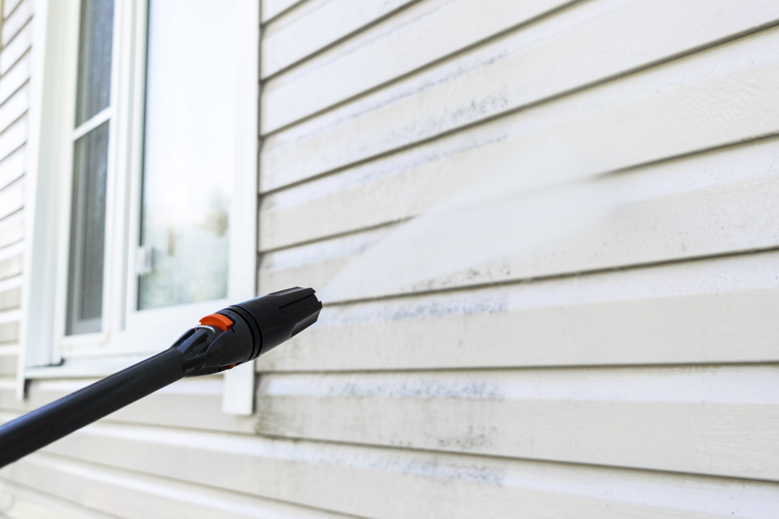 Pressure washing old vinyl siding