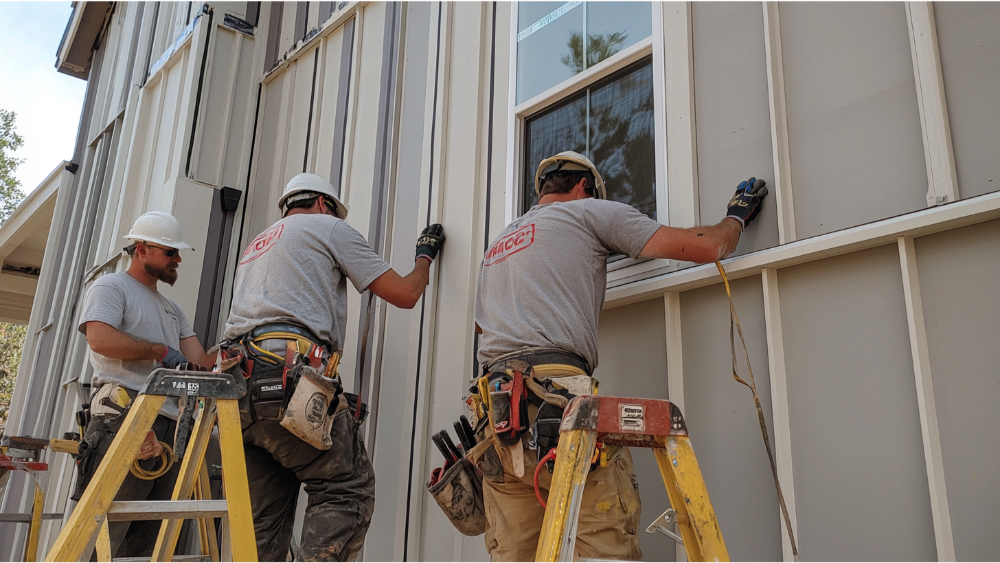 A team installing reverse board and batten siding