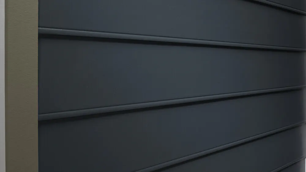 How Much Does It Cost To Replace Siding? The Cost Of 8 Popular Siding Styles 12 A close up of fiber cement siding