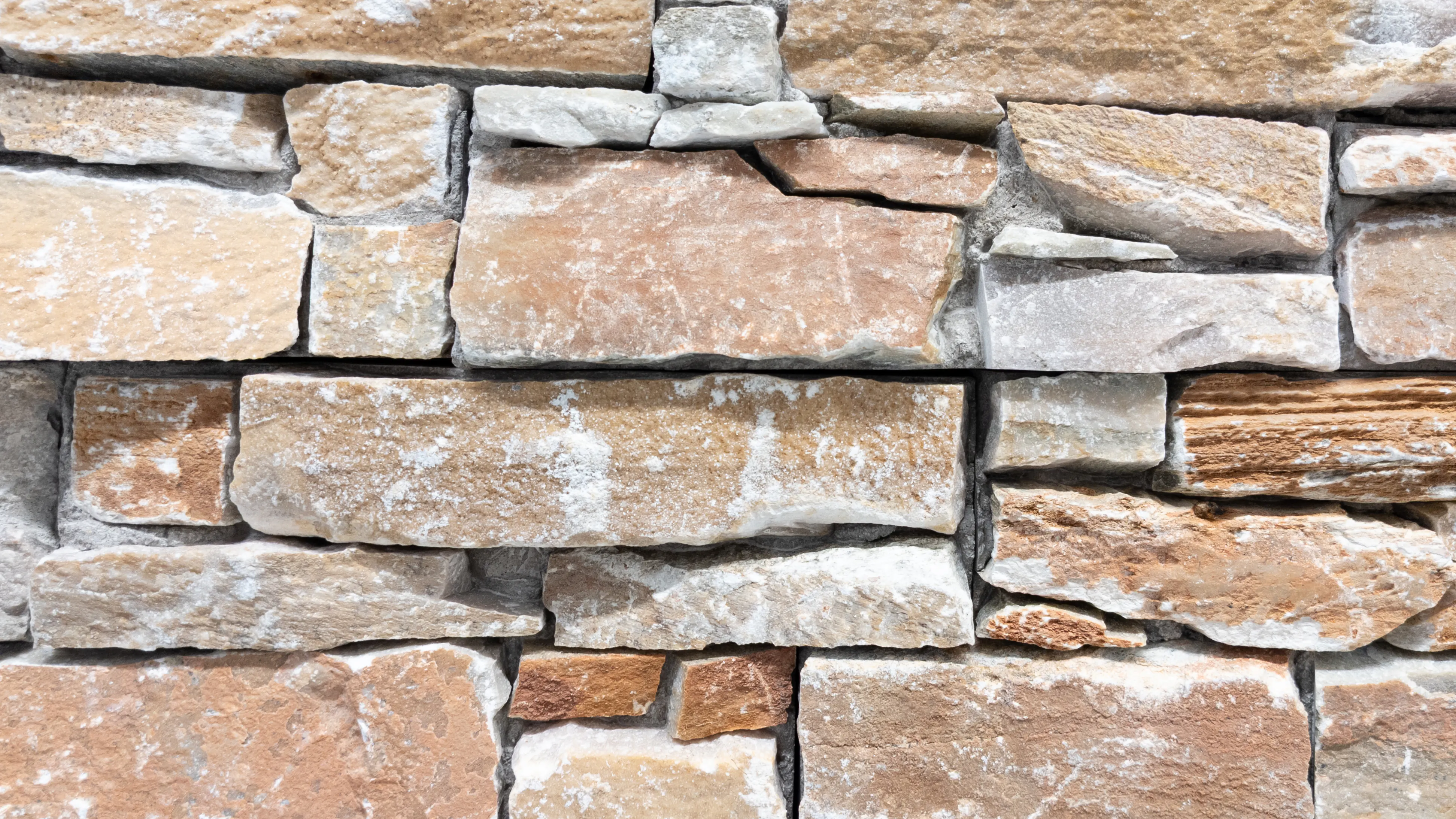 How Much Does It Cost To Replace Siding? The Cost Of 8 Popular Siding Styles 14 A close up of stone siding